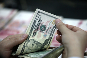 China's forex reserves post biggest monthly drop on record